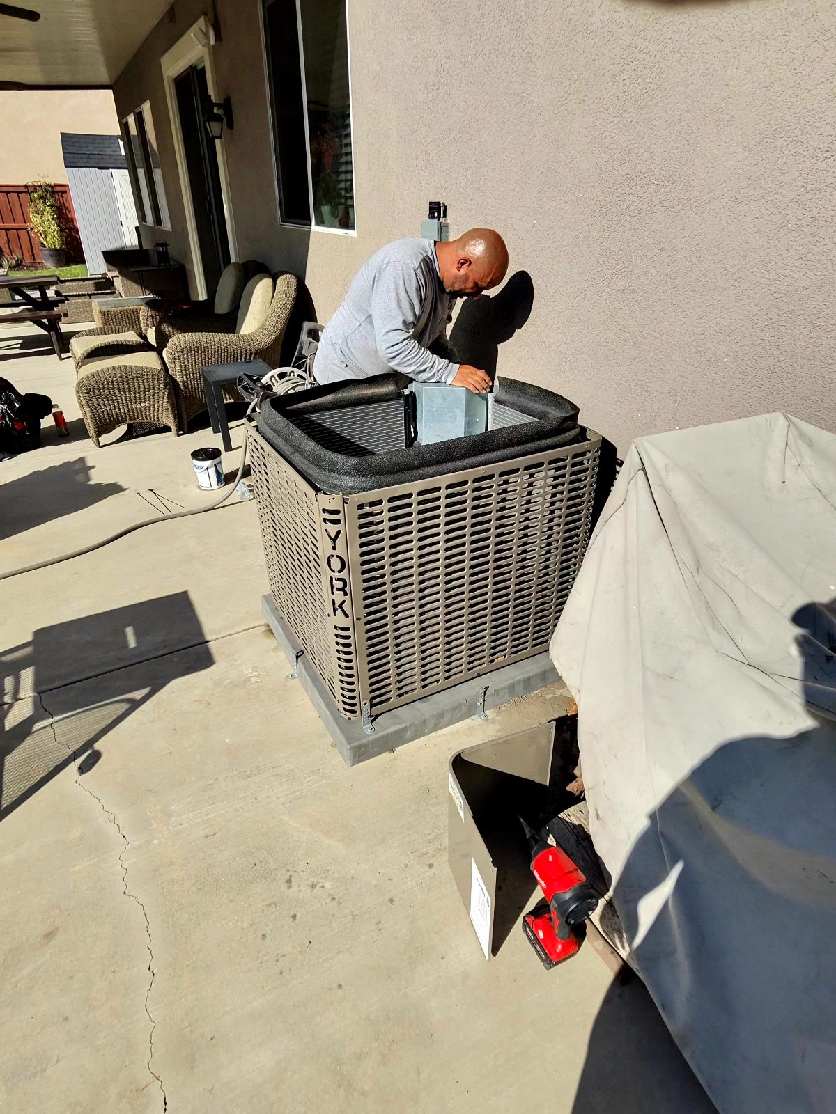 VORXS technician servicing a York AC condenser at an Orange County home on a no-cool call
