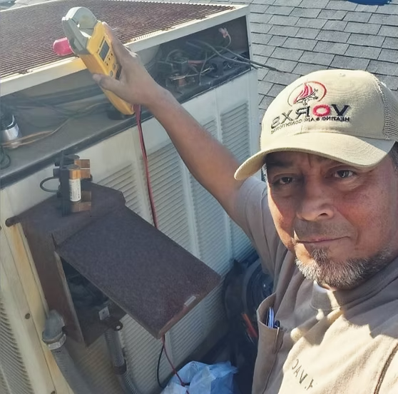 Albert's dad working on an HVAC system before VORXS Heating & Air Conditioning