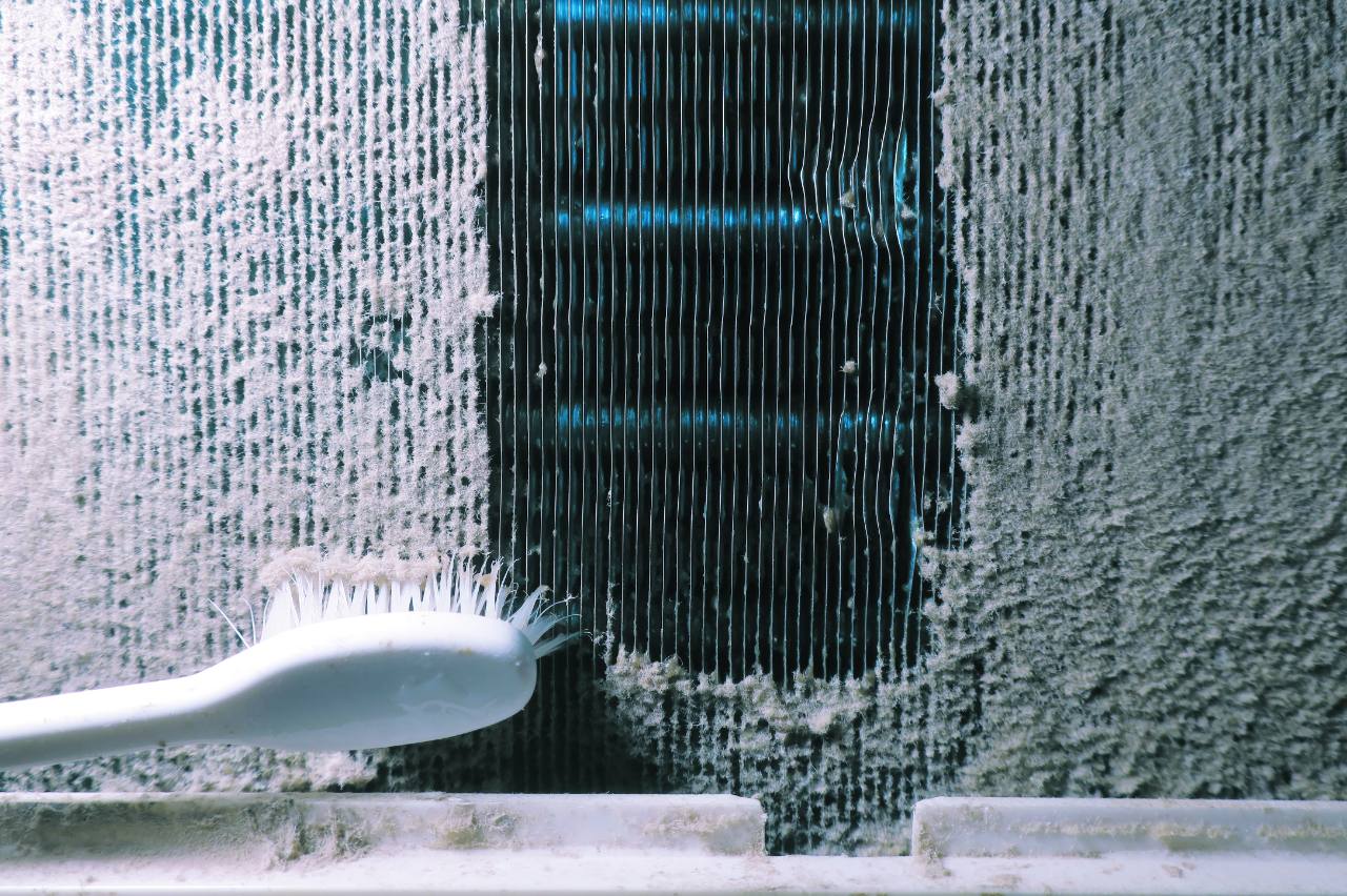 A toothbrush cleaning dust from an evaporator coil