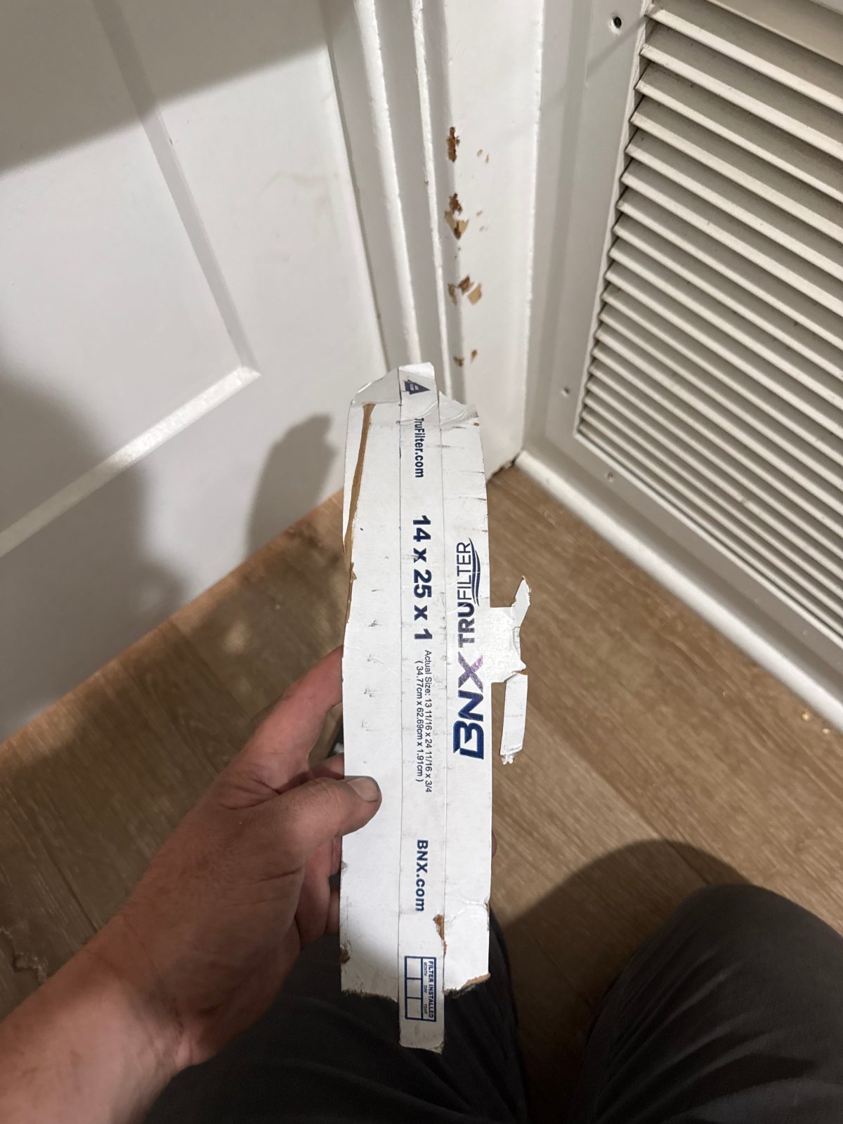 Cardboard from air filter removed from HVAC blower during Fullerton service call