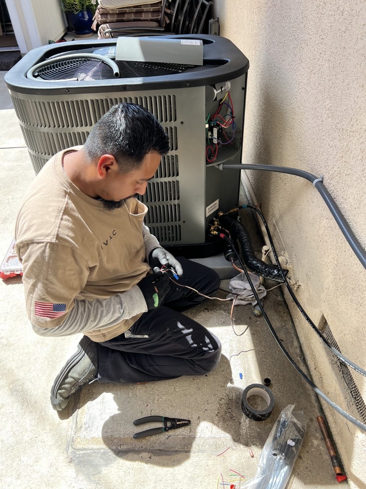 VORXS technician wiring a new AC condenser during an Orange County installation